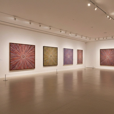 Modern art gallery interior showcasing large scale Indigenous Australian paintings